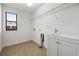 Bright laundry room with utility sink and shelving at 7119 Peregrina Loop, Wesley Chapel, FL 33545