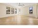 Sunlit living room with tile floors and ceiling fan at 7119 Peregrina Loop, Wesley Chapel, FL 33545