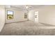 Main bedroom with carpeted floors and multiple windows at 7119 Peregrina Loop, Wesley Chapel, FL 33545