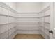 Walk-in pantry with ample shelving for storage at 7119 Peregrina Loop, Wesley Chapel, FL 33545