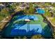 Two tennis courts with shade structure at 7119 Peregrina Loop, Wesley Chapel, FL 33545