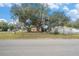 Mobile home with large shade tree and outbuildings at 7401 Mount Vernon Rd, Tampa, FL 33625