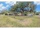 Mobile home with large shade tree and outbuildings at 7401 Mount Vernon Rd, Tampa, FL 33625