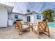 Relaxing patio area with wooden furniture and pool access at 7601 9Th N Ave, St Petersburg, FL 33710