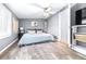 Main bedroom with king-size bed, wood-look floors, and ceiling fan at 7601 9Th N Ave, St Petersburg, FL 33710