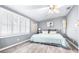 Main bedroom with king-size bed, wood-look floors, and ceiling fan at 7601 9Th N Ave, St Petersburg, FL 33710