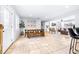 Bright dining area with wood table and bench, view to living room at 7601 9Th N Ave, St Petersburg, FL 33710