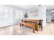 Dining area with wood table, bench, and adjacent kitchen at 7601 9Th N Ave, St Petersburg, FL 33710