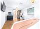 Main bedroom with barn door, herringbone floors and ensuite bathroom at 7601 9Th N Ave, St Petersburg, FL 33710