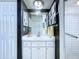 Bright bathroom with white vanity, shower, and dark accent wall at 7923 Leighton Cir, New Port Richey, FL 34654