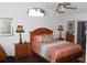 Main bedroom with wood furniture, arched window, and sliding glass doors at 7923 Leighton Cir, New Port Richey, FL 34654