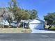 Charming one-story home featuring an attached two-car garage and a well-manicured front yard at 7923 Leighton Cir, New Port Richey, FL 34654