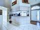 View of the kitchen and bar featuring tile floors and view of the front door at 7923 Leighton Cir, New Port Richey, FL 34654