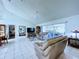 Living room with vaulted ceiling, tile floors and sliding glass doors to the pool at 7923 Leighton Cir, New Port Richey, FL 34654