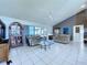 Bright living room with tile floors, vaulted ceiling with fan and sliding doors to the pool at 7923 Leighton Cir, New Port Richey, FL 34654