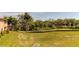 Landscaped backyard with grassy area and canal view at 820 Date Palm Ln, St Petersburg, FL 33707