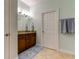 Bathroom with granite countertop, tiled floor, and linen towels at 820 Date Palm Ln, St Petersburg, FL 33707