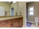 Bathroom with granite countertop, wooden cabinets and shower at 820 Date Palm Ln, St Petersburg, FL 33707