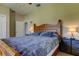 King-size bed in bedroom with wood furniture and access to another room at 820 Date Palm Ln, St Petersburg, FL 33707