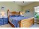 King-size bed in bedroom with wood furniture and large window at 820 Date Palm Ln, St Petersburg, FL 33707