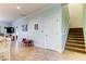 Bright hallway with stairs, tile flooring and artwork at 820 Date Palm Ln, St Petersburg, FL 33707