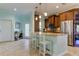 Open kitchen with island, stainless steel appliances, and light blue walls at 820 Date Palm Ln, St Petersburg, FL 33707