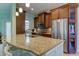 Kitchen with granite countertop, stainless steel appliances, and wooden cabinets at 820 Date Palm Ln, St Petersburg, FL 33707