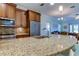 Kitchen island with granite countertop and stainless steel sink and faucet at 820 Date Palm Ln, St Petersburg, FL 33707