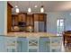 Kitchen with granite island, pendant lighting, and wooden cabinets at 820 Date Palm Ln, St Petersburg, FL 33707