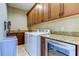 Well-equipped laundry room with washer, dryer, and ample cabinetry at 820 Date Palm Ln, St Petersburg, FL 33707