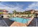 Community pool area with lounge chairs and umbrellas at 820 Date Palm Ln, St Petersburg, FL 33707