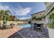 Community pool with lounge chairs and a table with chairs at 820 Date Palm Ln, St Petersburg, FL 33707