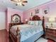 Elegant bedroom with a large wooden bed frame and a dresser at 9516 Cypress Harbor Dr, Gibsonton, FL 33534