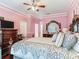 Bright bedroom with a large bed, dresser and a TV at 9516 Cypress Harbor Dr, Gibsonton, FL 33534