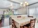 Bright dining room with chandelier and view into the living room at 9516 Cypress Harbor Dr, Gibsonton, FL 33534