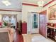 Entryway with red and white walls, and view into living room at 9516 Cypress Harbor Dr, Gibsonton, FL 33534