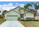 One-story house with light green walls and palm trees at 9516 Cypress Harbor Dr, Gibsonton, FL 33534