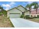 House exterior with two-car garage at 9516 Cypress Harbor Dr, Gibsonton, FL 33534