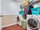 Laundry room with washer, dryer, and shelving at 9516 Cypress Harbor Dr, Gibsonton, FL 33534