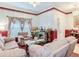 Living room with beige sofas, a fireplace, and hardwood floors at 9516 Cypress Harbor Dr, Gibsonton, FL 33534