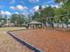 Community playground with swings, playset, and shaded seating at 9516 Cypress Harbor Dr, Gibsonton, FL 33534