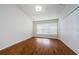 Well-lit bedroom featuring wood flooring and large windows at 10425 Westpark Preserve Blvd, Tampa, FL 33625