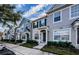 Row of modern townhomes with neutral gray exteriors, well-maintained landscaping, and inviting entryways at 10425 Westpark Preserve Blvd, Tampa, FL 33625