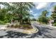 Gated entrance to a community with landscaped medians and trees at 10425 Westpark Preserve Blvd, Tampa, FL 33625