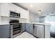 Stylish kitchen featuring stainless steel appliances and a marble backsplash at 10425 Westpark Preserve Blvd, Tampa, FL 33625