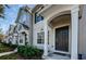 Front entrance of a townhouse, featuring a dark brown door and porch at 10425 Westpark Preserve Blvd, Tampa, FL 33625