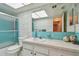 Bathroom with teal tile, vanity, and shower/tub combo at 11200 102Nd Ave # 138, Seminole, FL 33778