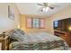 Large bedroom with a king-size bed, TV and ceiling fan at 11200 102Nd Ave # 138, Seminole, FL 33778