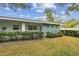 Ranch style home with light blue exterior, well-manicured lawn, and hedges at 11200 102Nd Ave # 138, Seminole, FL 33778