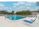 Community pool with lounge chairs and surrounding foliage at 11200 102Nd Ave # 138, Seminole, FL 33778